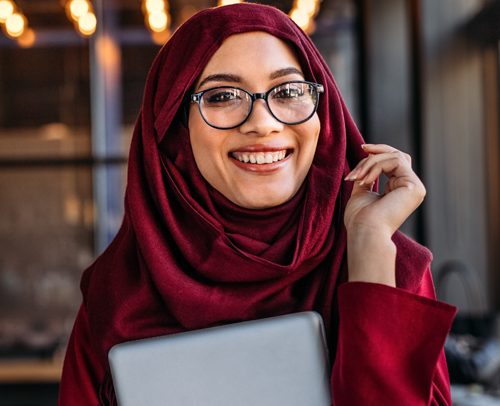 Woman wearing head covering smiling at the camera