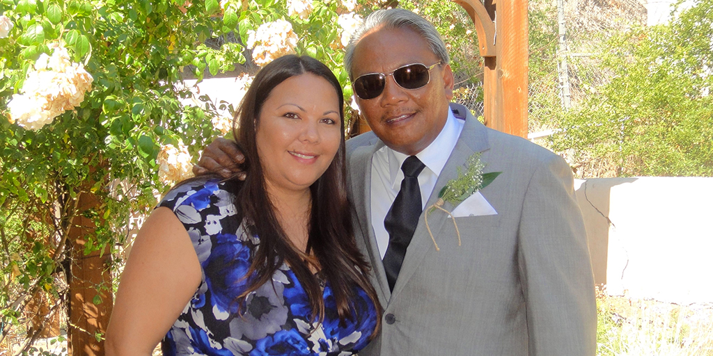 Photo shows a woman and an older man smiling.